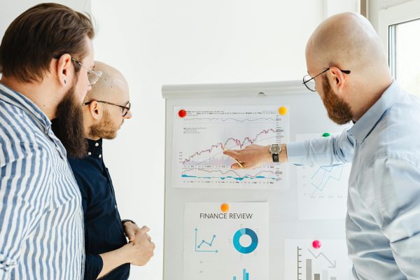 Brisbane business owner in a strategy meeting with mortgage broker and accountant reviewing financial documents